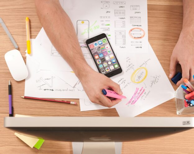 phone on top of papers on a desk