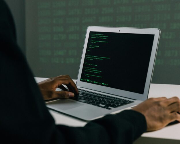 man coding on his laptop