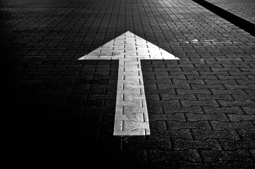 White Arrow on Black Bricks