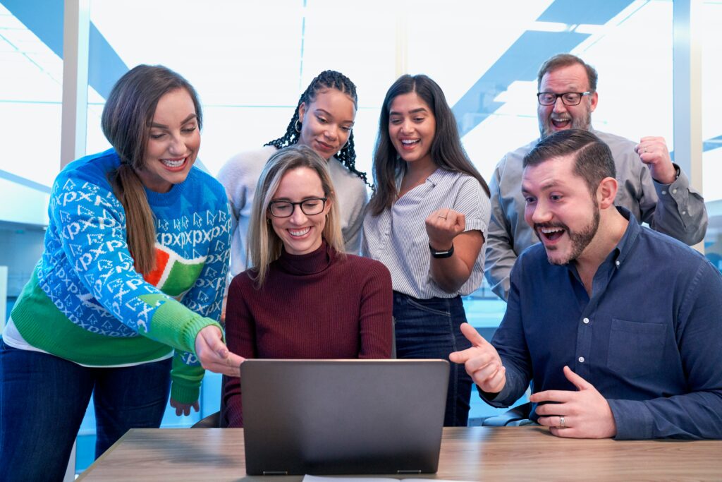group of people around a laptop
