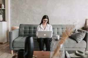 A Woman Smiling at Her Laptop