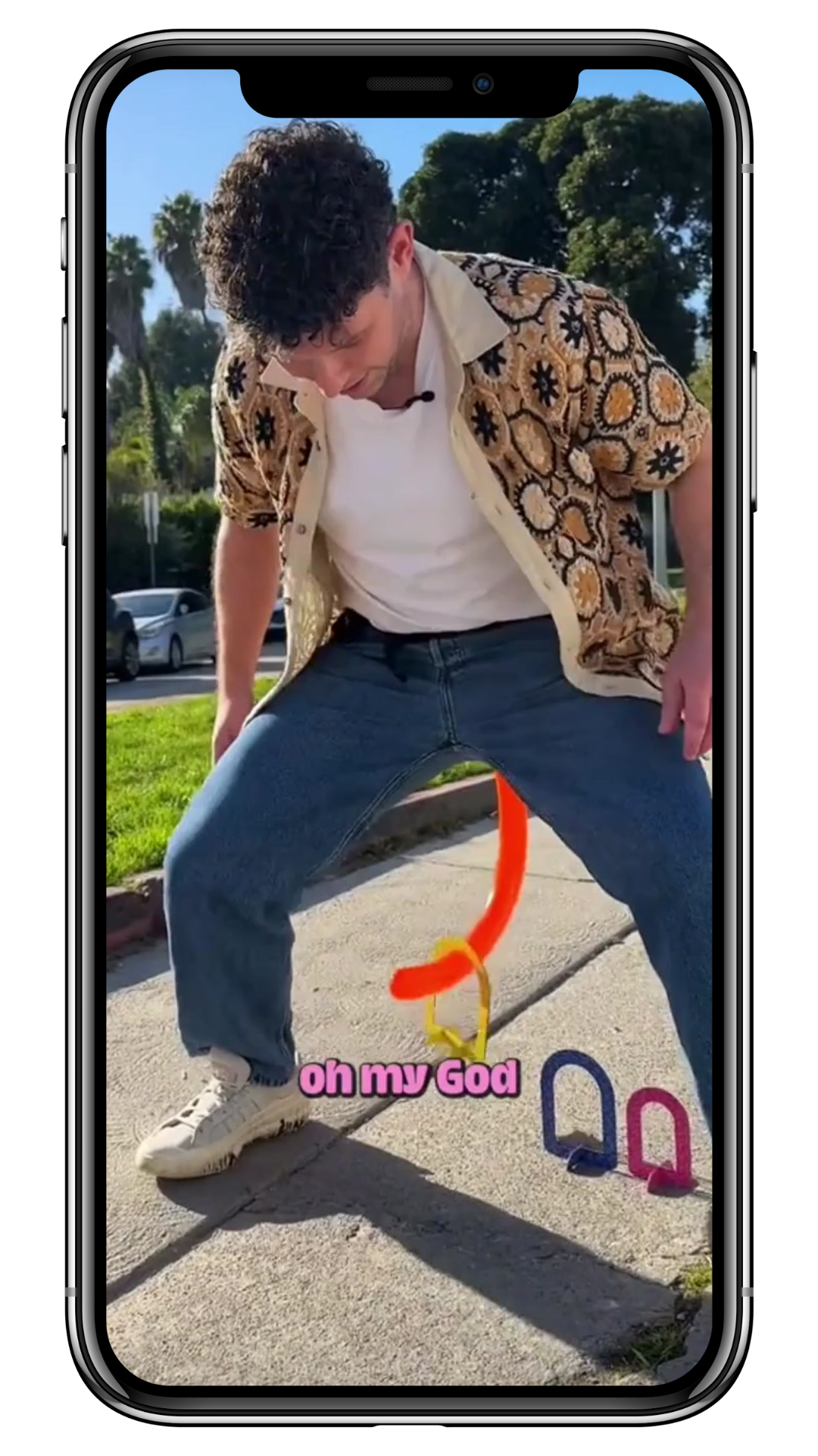 A TikTok screenshot: a man plays a game trying to lift a ring with a fake tail. Caption: oh my god.