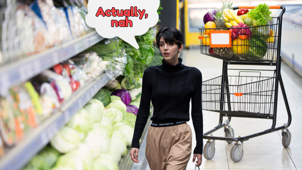 A woman abandons her cart at the supermarket. A speech. bubble reads 'Actually, nah'.